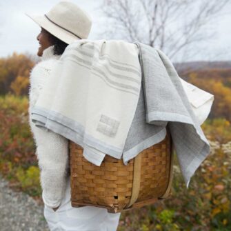 Swans Island Company's classic handwoven throws. Shown here the Grace throw in natural with grey stripes and the Heritage Throw in Grey with natural stripes.
