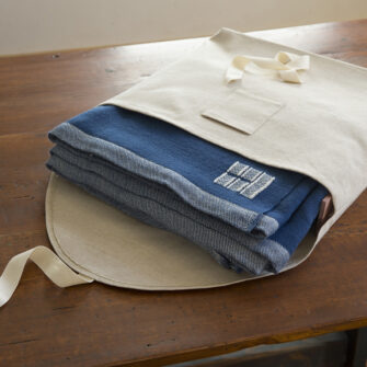 Swans Island handwoven Katahdin and Firefly blankets come in a custom linen bag. Aromatic cedar slats keep you blanket fresh when not in use.