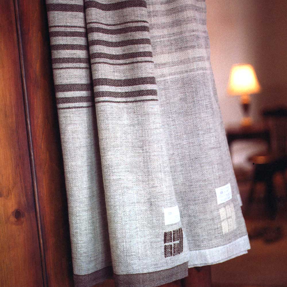 blanket hanging by wood paneled wall
