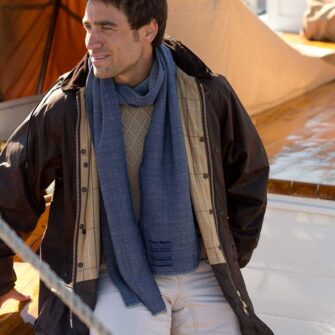 Swans Island Company's Camden Scarf is handwoven in Maine. Hand-dyed wool yarn gives each scarf one-of-a-kind flair. This unisex design makes a great gift for everyone. Shown here in indigo.