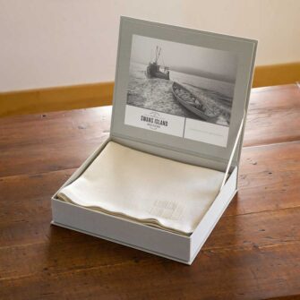 Swans Island Co. handwoven throws come in a beautiful grey linen gift box.