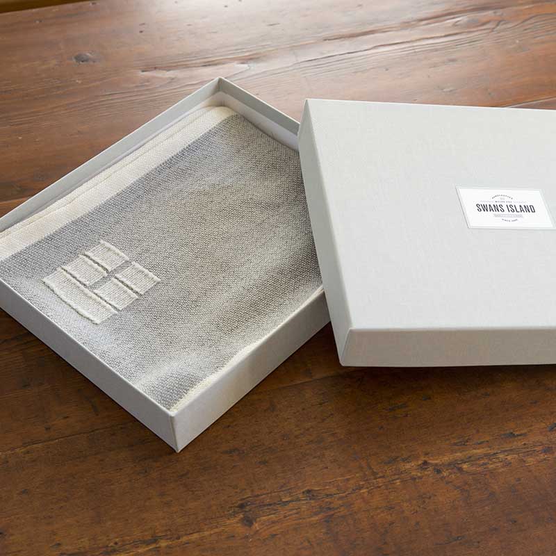 Swans Island handwoven scarf in custom grey linen gift box.