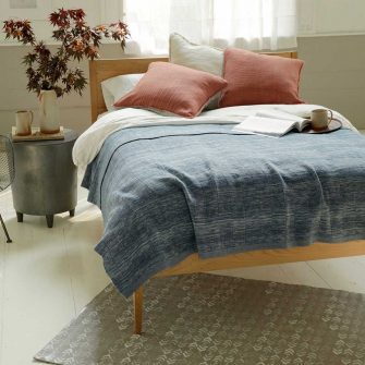 Swans Island Company's Handwoven Winter blanket is handcrafted in Maine with 100% wool from small farms. Hand-dyed with all-natural indigo and woven in a double layer construction for extra warmth. Shown here in Ikat Indigo.