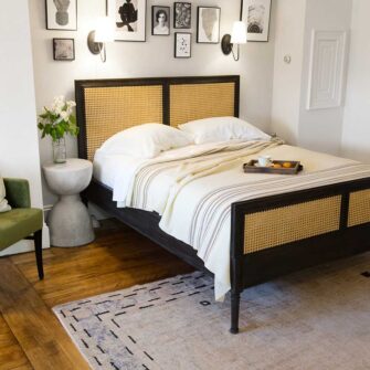 Swans Island Grace Blanket. Handwoven in Maine. 100% wool. Shown here in natural with brown stripes on a queen bed.