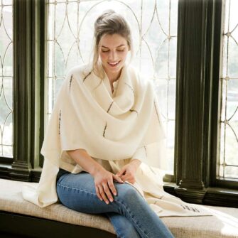 The Swans Island Whitecaps Cape is handwoven in Maine with soft merino wool with bits of textured wool reminiscent of whitecaps on the water.