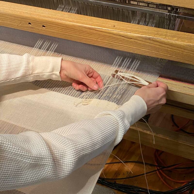 Stillwater Ranch x Swans Island Collaboration '21. Hand-weaving the weaver's mark at the Swans Island Studio, Northport, Maine.