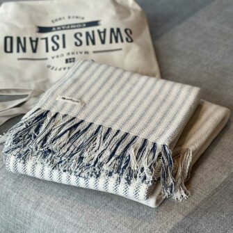 Swans Island's Cotton Ticking Throw Fringe blanket is woven in Maine with 100% American cotton.