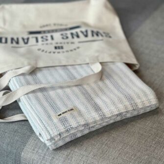 Swans Island's Cotton Ticking Throw blanket is woven in Maine with 100% American cotton.