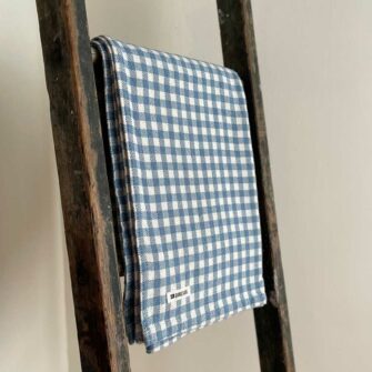 Swans Island's classic Gingham Check Throw blanket is woven in Maine with 100% natural cotton.