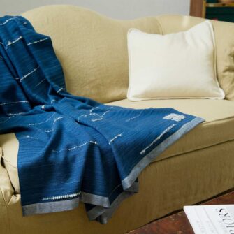 Swans Island's White Caps Throw - handwoven with 100% hand-dyed merino wool. Made in Maine. Shown here in Indigo with Natural.