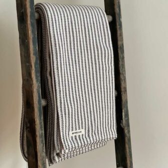 Swans Island's Cotton Ticking Throw blanket is woven in Maine with 100% American cotton.