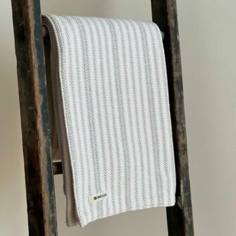 Swans Island's Cotton Ticking Throw blanket is woven in Maine with 100% American cotton.