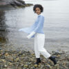 A model wears a Swans Island Firefly Ruana knit with hand-dyed merino wool and silk yarns.