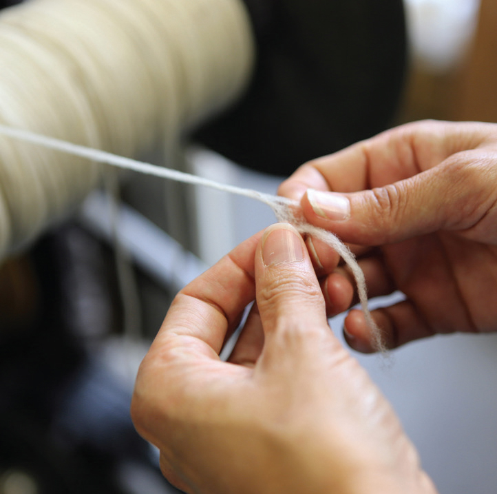 Inspecting wool roving as it gets spun into yarn for Swans Island blankets. At the Green Mountain Spinnery in Vermont.