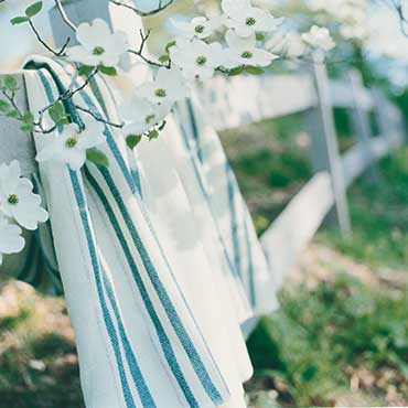 handwoven Grace blanket draped over fence