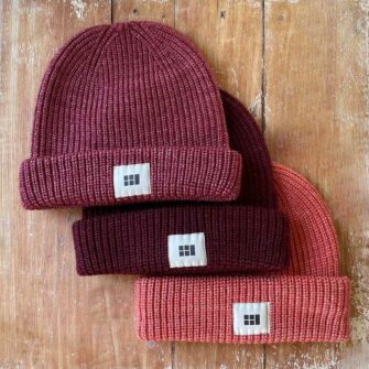 Swans Island Fisherman's Beanie - Knit in USA with soft, hand-dyed silk merino wool shown in Cranberry, Burgundy, Persimmon.
