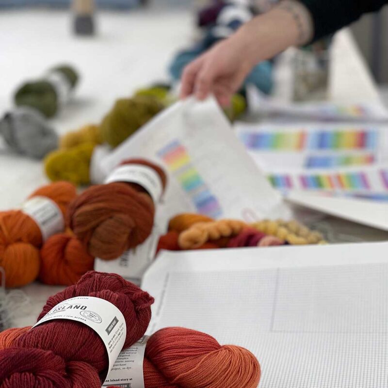 Swans Island Company's Limited Edition Prism Series. Nine rainbow-inspired throws designed by our team of talented weavers. Each throw in this limited edition drop is unique! Many of our hand-dyed yarns are laid out for consideration alongside sketch of design concepts by our weavers.