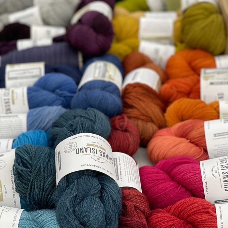 Swans Island Company's Limited Edition Prism Series. Nine rainbow-inspired throws designed by our team of talented weavers. Each throw in this limited edition drop is unique! Here are skeins of some of the many hand-dyed Swans Island yarns used to make the Prism Throws.