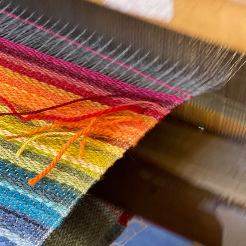 Swans Island Company's Limited Edition Prism Series. Nine rainbow-inspired throws designed by our team of talented weavers. Each throw in this limited edition drop is unique! A rainbow of wool colors is on the loom.