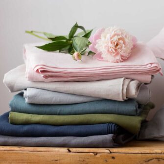Swans Island Company's Relaxed Linen Sheet Set. 100% French linen made in the USA, breathable, soft and regulates temperature as you sleep. Comes in 7 colors - Dove, Slate, Blush, Midnight, Rosemary, Aegean, Seaspray.
