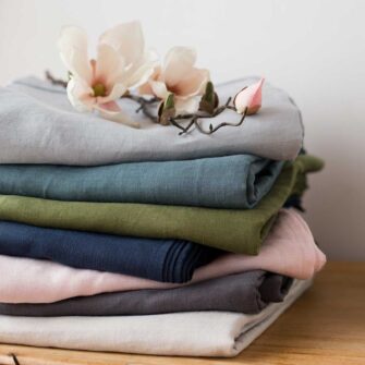 Swans Island Company's Relaxed Linen Sheet Set. 100% French linen made in the USA, breathable, soft and regulates temperature as you sleep. Comes in 7 colors - Dove, Slate, Blush, Midnight, Rosemary, Aegean, Seaspray.