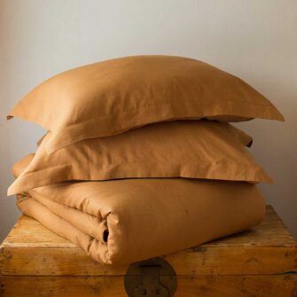 Swans Island Company's Relaxed Linen bedding is made with 100% French linen, stitched in the USA. Shown here, duvet set in Golden Honey.