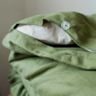 Swans Island Company's Relaxed Linen Sheet Set is made with 100% French linen, stitched in the USA. Button closure on duvet cover, shown here in Rosemary.