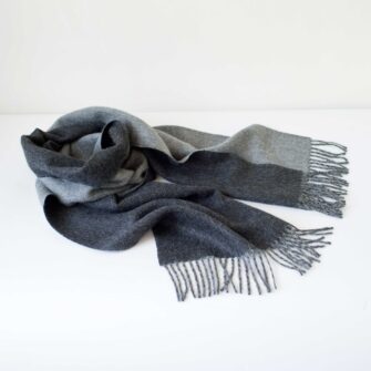 Swans Island Company's Reversible Baby Alpaca Scarf is a luxurious, soft scarf for men and women. Shown here in Charcoal /LIght Gray colorway.