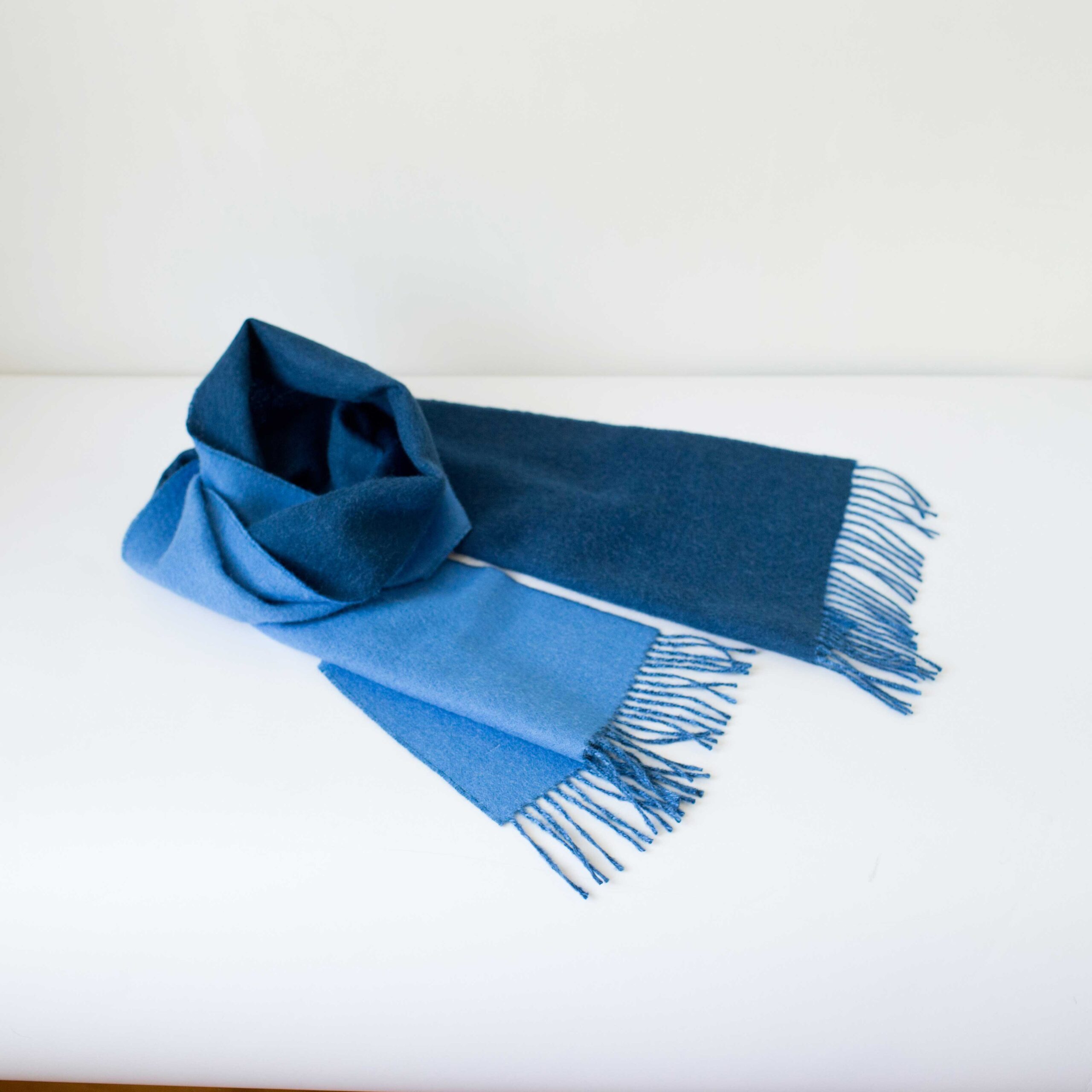 Swans Island Company's Reversible Baby Alpaca Scarf is a luxurious, soft scarf for men and women. Shown here in Sky Blue / Marine Blue colorway.