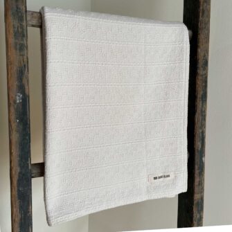 Swans Island Company's Bedford Throw. 100% Cotton throw with bands of woven texture in Natural undyed 100% American cotton.