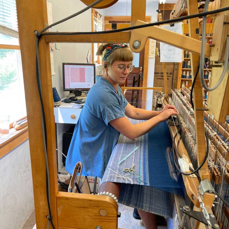 Swans Island Co. Ocean Limited Edition Throws - Chloe, at the loom weaving one of the eleven unique throws.