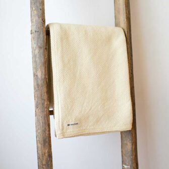 Swans Island Company's Belgrade Borders Throw is made in Maine with soft lofty cotton.. Extra soft and cuddly throw is shown here in Straw color.