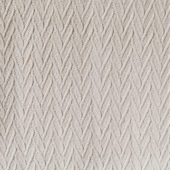 Swans Island Company's Charisma Blanket. Soft 100% Cotton blanket with woven herringbone texture. Made in USA with 100% American cotton. Shown here in Taupe. Swatch