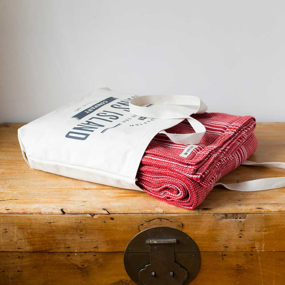 Swans Island Company's Cotton Pick Stripe Blanket. Soft 100% Cotton blanket with yarn-dyed woven stripes. Made in USA with 100% American cotton. Each blanket comes in a signature cotton tote.