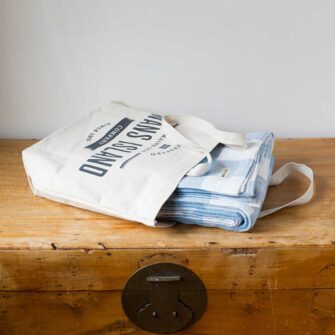 Swans Island Company's Cotton Gingham XL Check Blanket - woven in Maine on antique looms. Made with 100% soft American cotton. Each blanket comes in our signature cotton canvas tote.