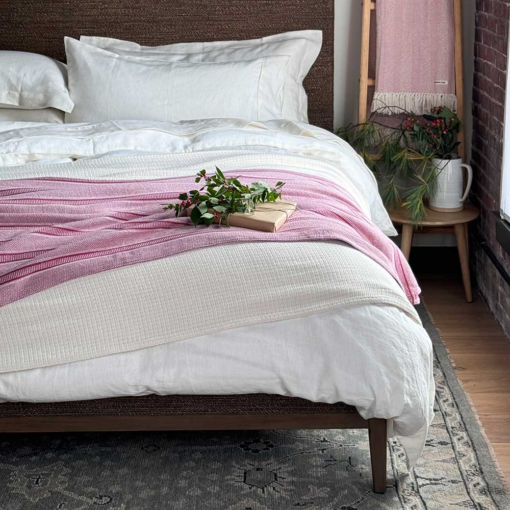 Swans Island Company's Cotton Tulare Blanket. Soft 100% Cotton blanket with yarn-dyed woven stripes. Made in USA with 100% American cotton. Shown here in Rose.