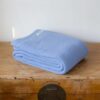 Swans Island Company's Tuscany Cotton Blanket. Soft 100% Cotton blanket woven with an allover basketweave texture. Made in Maine, USA. Shown here in French Blue.