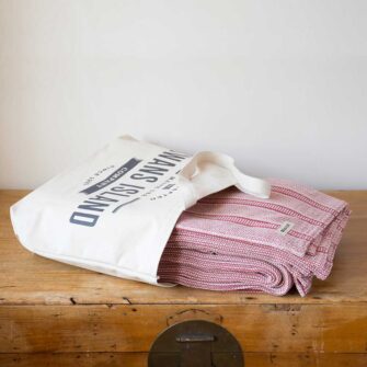 Swans Island Company's Cotton Tulare Blanket. Soft 100% Cotton blanket with yarn-dyed woven stripes. Made in USA with 100% American cotton. Each blanket comes in our signature cotton canvas tote.