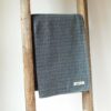 Swans Island Company's Silver Lining Throw. Made in USA, has an allover subtle textured design with an urban vibe. Cotton Wool blend. Shown here in Navy.