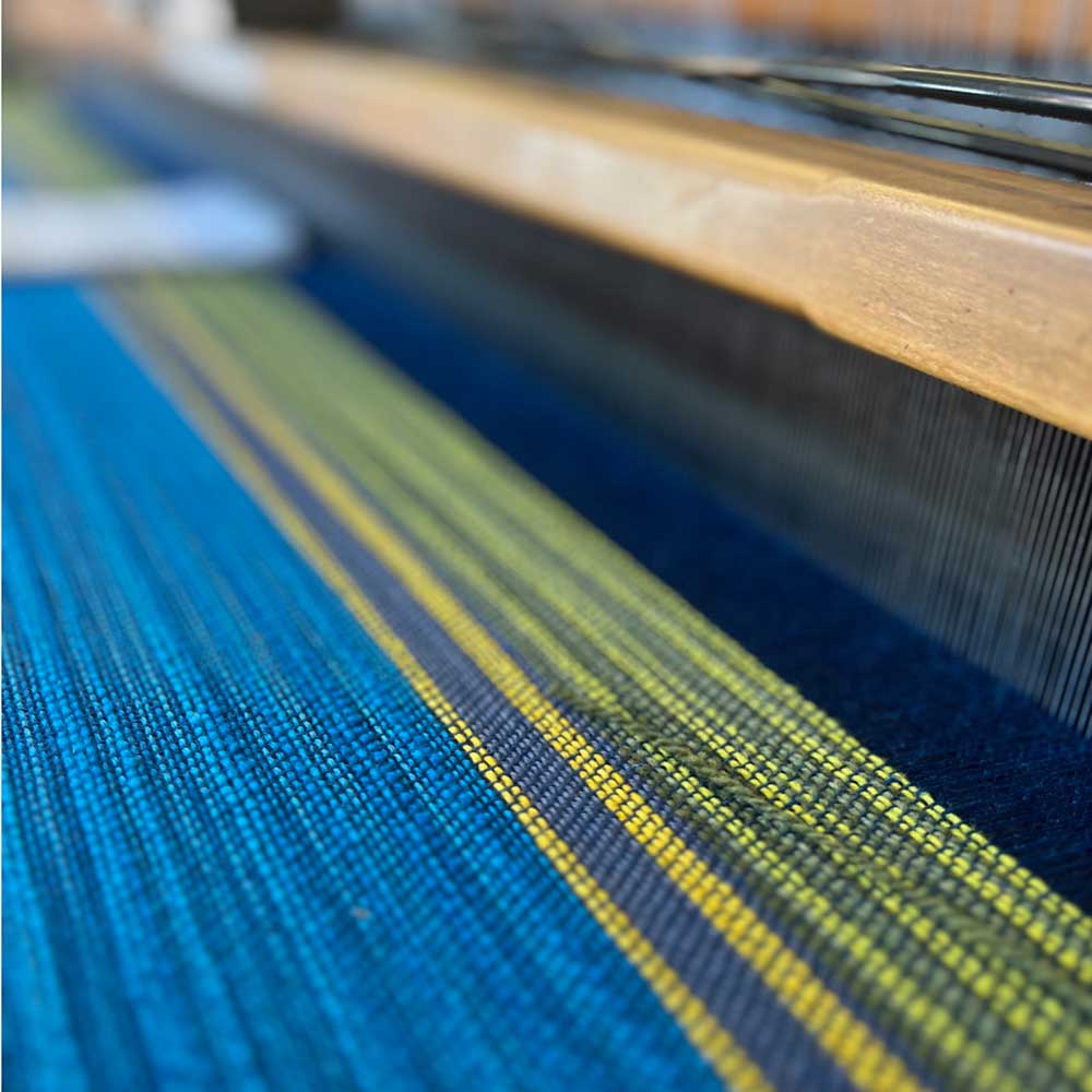 The Swans Island & Eric Hopkins Ltd. Edition Throw 2024. On the loom at Swans Island studios, Northport, Maine.