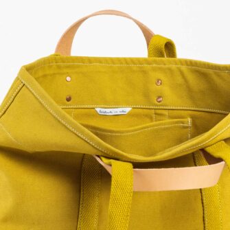 Swans Island Company's Small East West Tote in heavy cotton canvas - by Immodest Cotton. Chartreuse. Detail of interior.