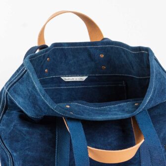 Swans Island Company's Small East West Tote in heavy cotton canvas - by Immodest Cotton. Dark Indigo. Detail of handles and interior.