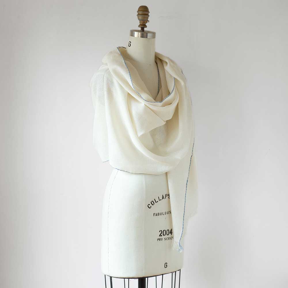 Swans Island Company's Royal Alpaca Whisper Shawl. Made of the softest alpaca with a hint of color woven in at the edges. Shown here in Ivory with Wedgwood.