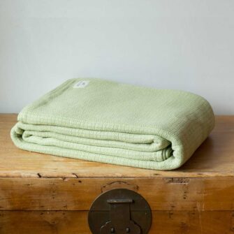 Swans Island Company's Tuscany blanket is woven in Maine with soft 100% American Cotton. Shown here in Celadon