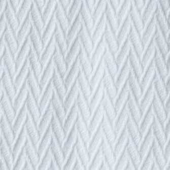 Swans Island Company's Charisma Throw. Soft 100% Cotton blanket with woven herringbone texture. Made in USA with 100% American cotton. Shown here in White. Swatch