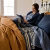 Swans Island Company's Harvest Linen Bedding Bundle. Combines a Relaxed Linen Sheet set in Midnight Blue with a Relaxed Linen Duvet Set in Golden Honey for a warm inviting bedroom retreat. Our French linen bedding is stitched in the USA.