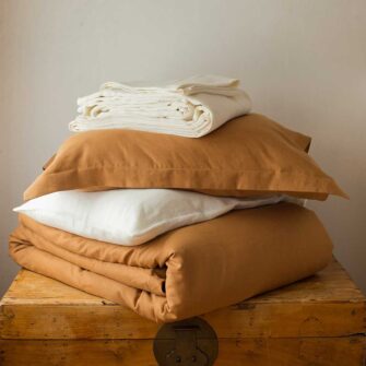 Swans Island Company's Golden Hour Bedding Bundle - Includes 1 Classic Linen Sheet Set in Ivory + 1 Relaxed Linen Duvet Set in Golden Honey. 100% French linen made in the USA.