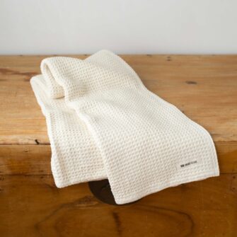 Swans Island Company's Cotton Waffle Toddler Blanket is squishy and soft - perfect for tender babes. Made in Maine with 100% American cotton. Shown here in Natural.