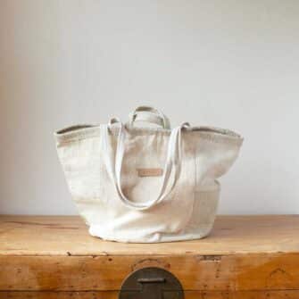 Swans Island Company's Quilt Basket Tote by Govou. Handcrafted in Spain from vintage linen grain sacks. Each bag is unique. Shown here in shades of natural. Size Medium.