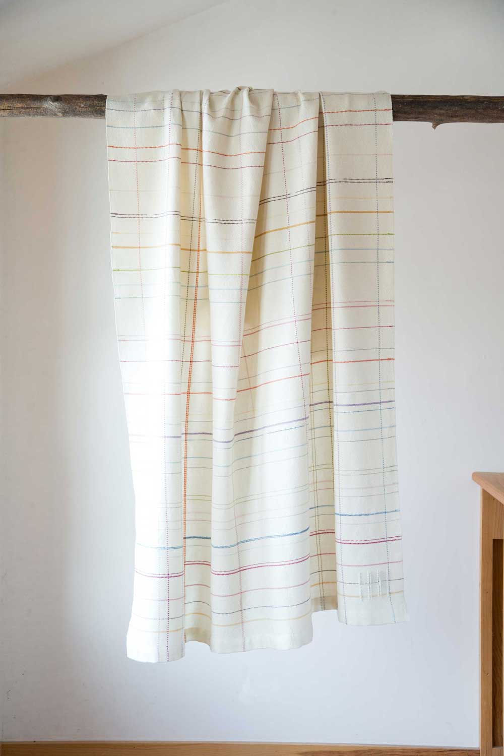 striped throw draped over pole